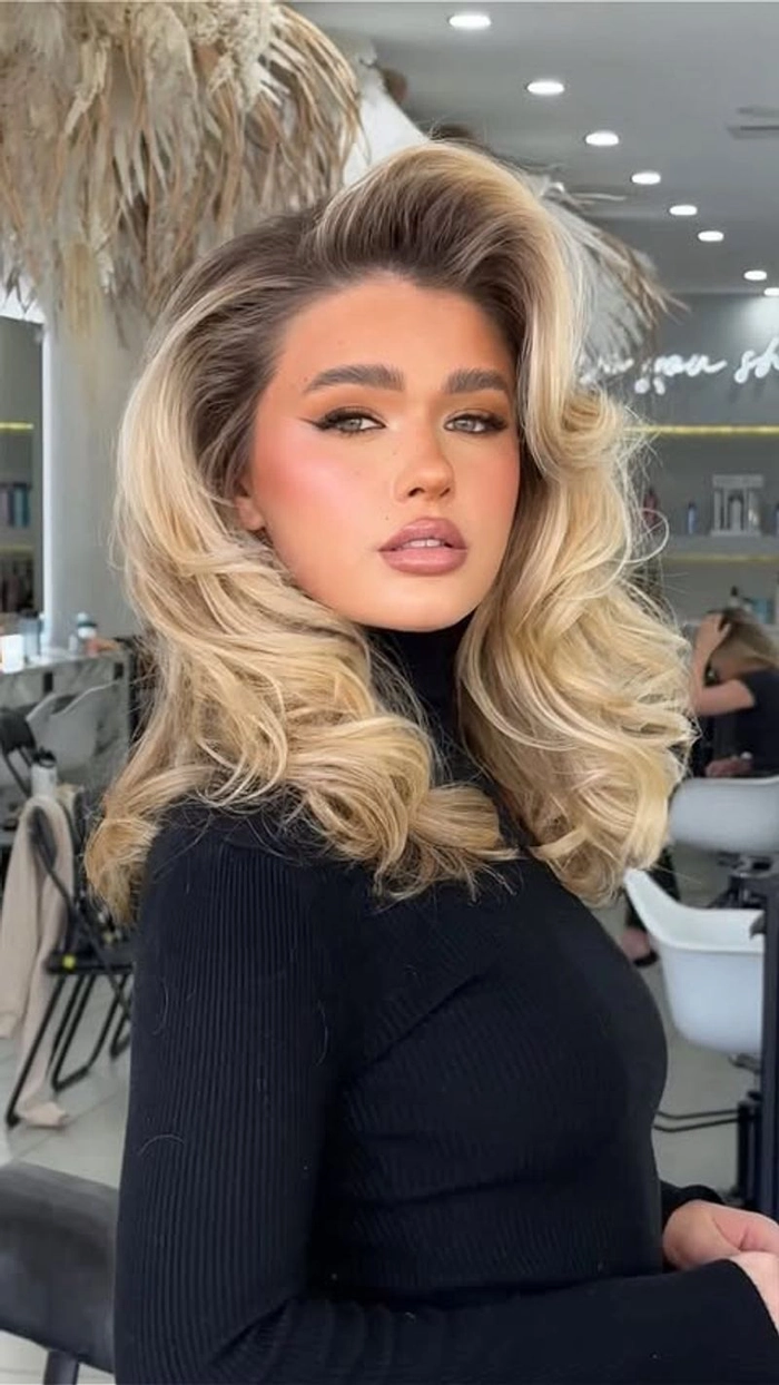 Relaxed bouncy blowout hairstyle on medium hair perfect for a casual weekend look