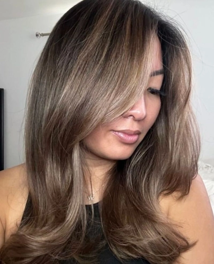 Relaxed bouncy blowout hairstyle on medium-length hair perfect for a casual weekend look