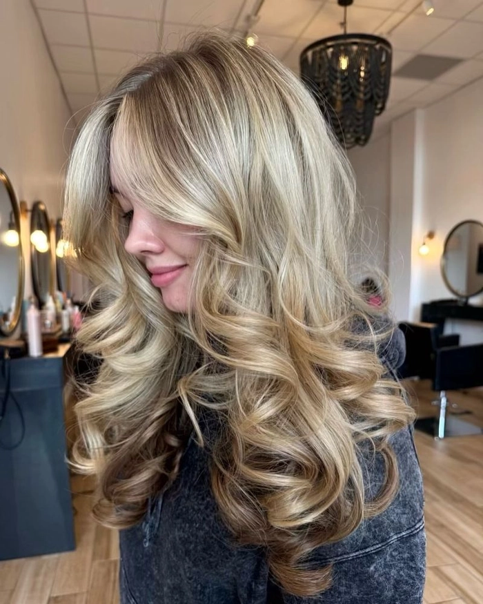 Relaxed bouncy blowout hairstyle on medium-length hair, perfect for a casual weekend look
