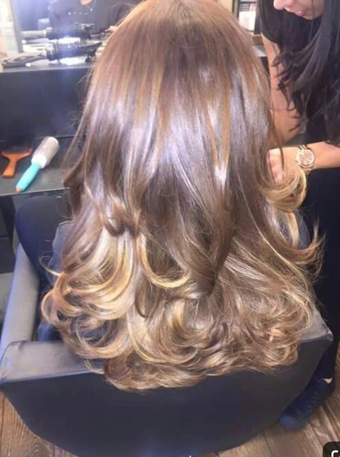 Relaxed bouncy blowout hairstyle on medium-length hair perfect for a casual weekend look