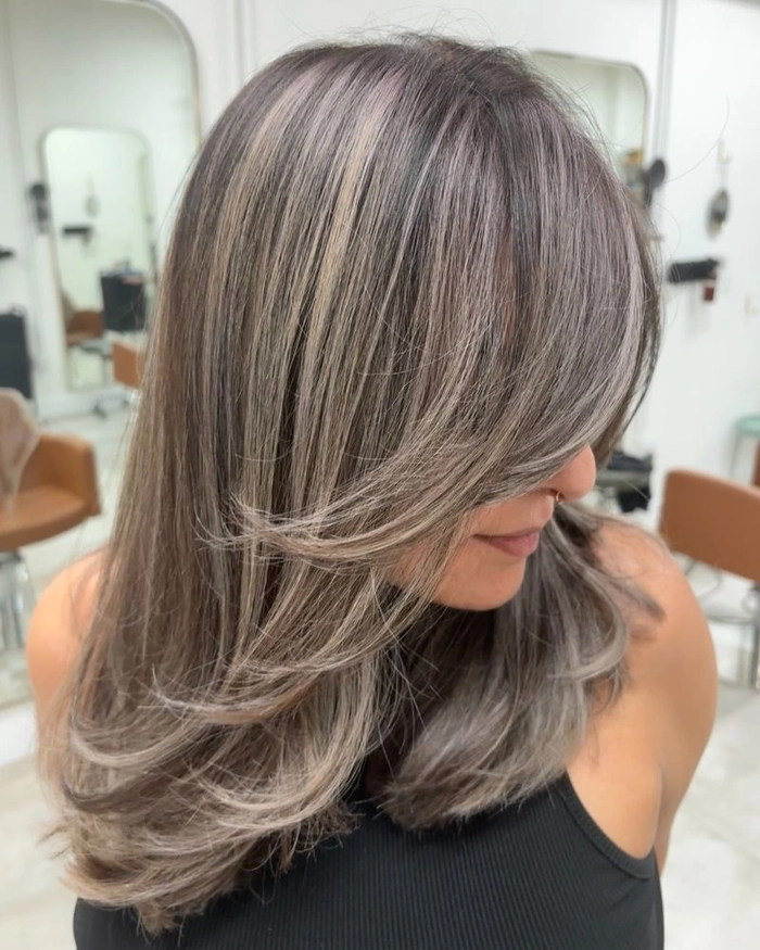 Relaxed bouncy blowout hairstyle on medium-length hair perfect for casual weekend looks