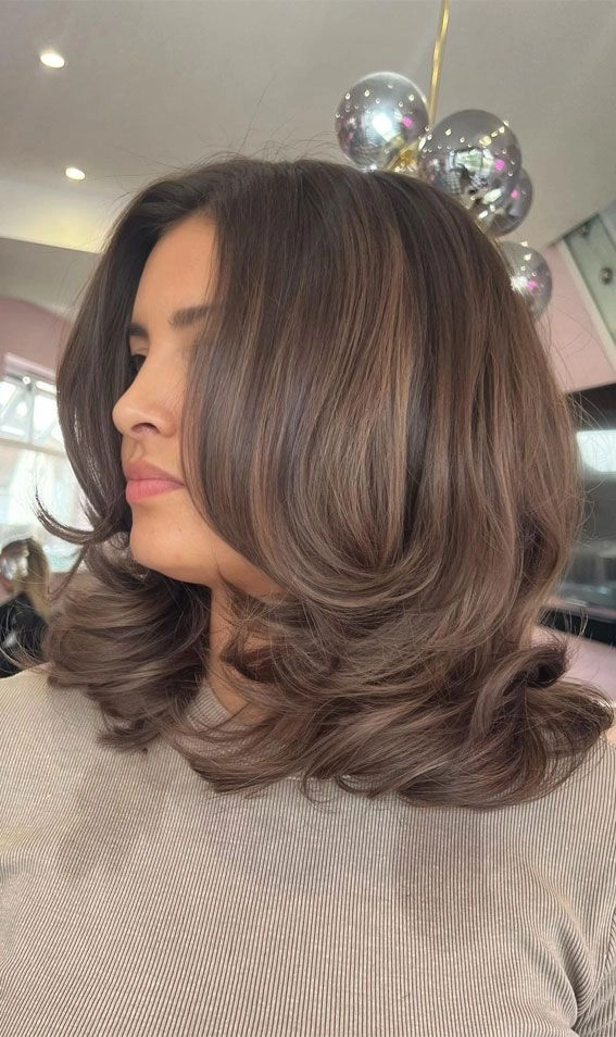 Relaxed bouncy blowout on medium-length hair perfect for a casual weekend look