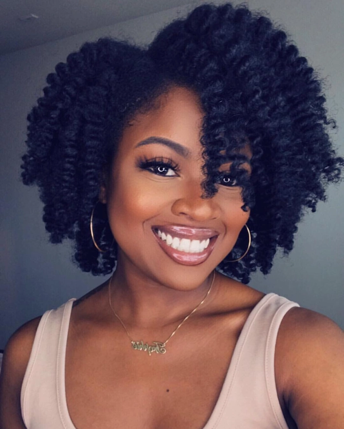 Casual relaxed braid out hairstyle on natural coils from image three Woman showcasing relaxed braid out hairstyle on natural coils for a casual look