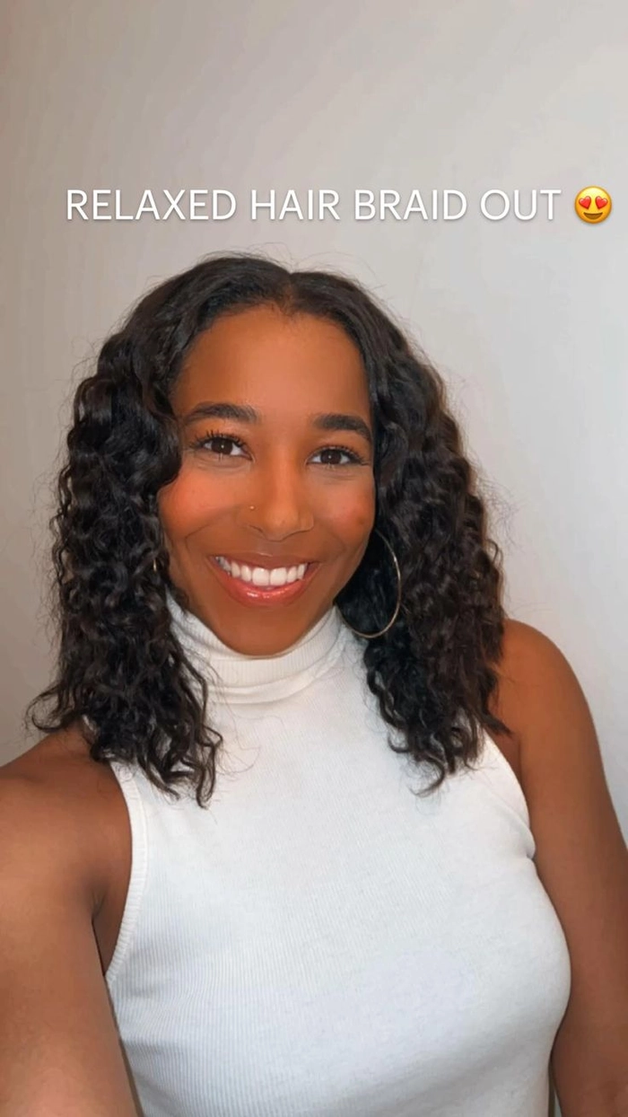 Casual hairstyle featuring relaxed braid out on natural coils, style number 7 Woman showcasing relaxed braid out hairstyle on natural coils for a casual look