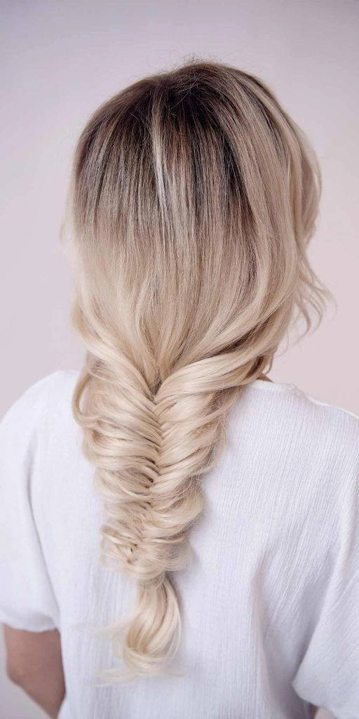 Relaxed fishtail braid hairstyle on thick wavy hair for a casual look