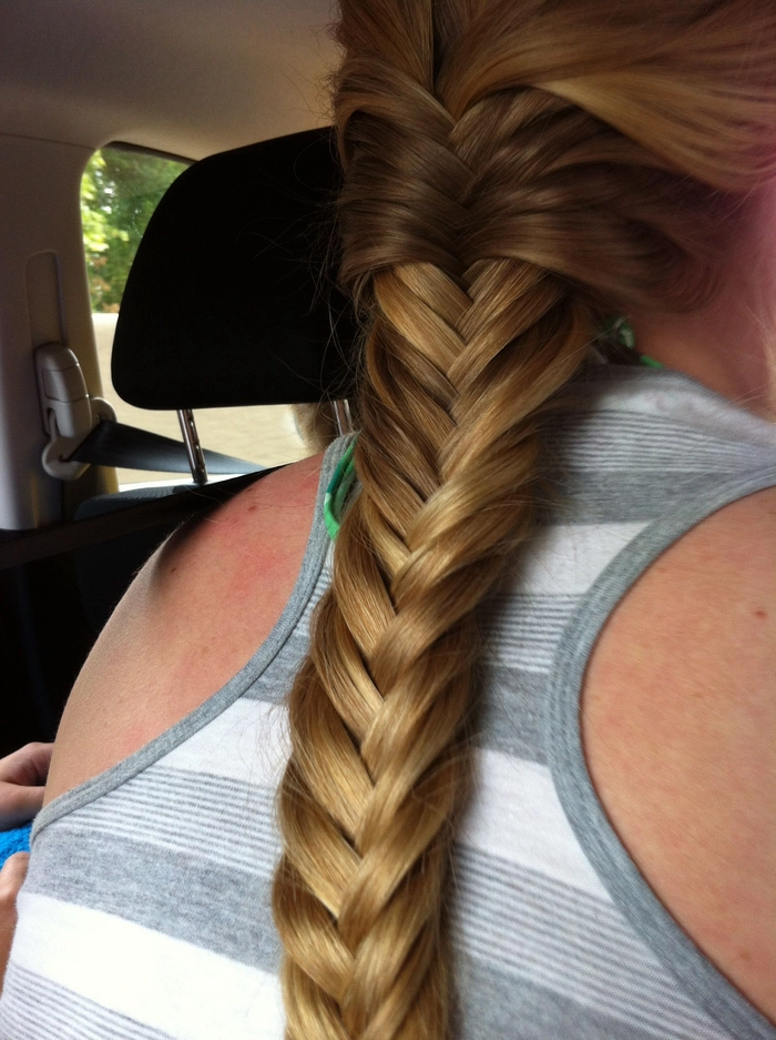 Relaxed fishtail braid on thick wavy hair for a casual look