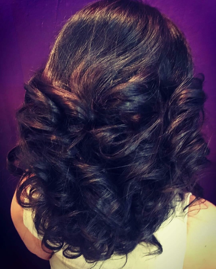Casual hairstyle featuring relaxed loose curls on medium length hair Relaxed loose curls styled on medium length hair for a casual look