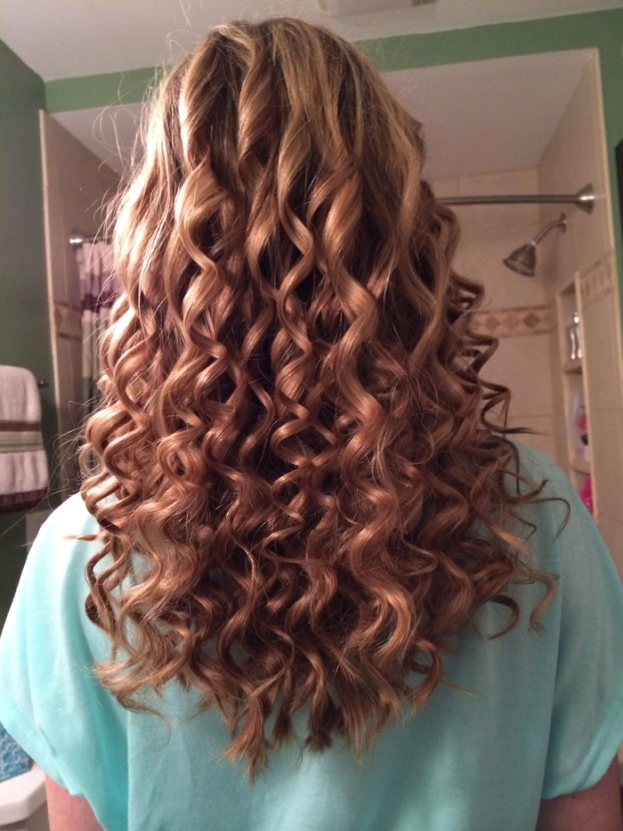 Casual hairstyle featuring relaxed loose curls on medium length hair Relaxed loose curls styled on medium length hair for a casual look