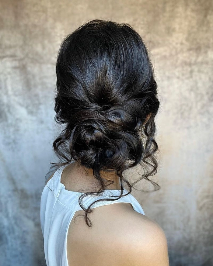 Woman with a relaxed low bun hairstyle perfect for women over 40