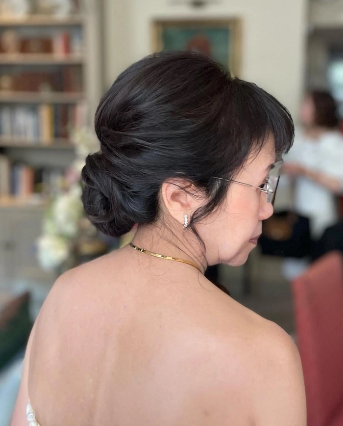 Relaxed low bun hairstyle on a woman over 40 with casual outfit