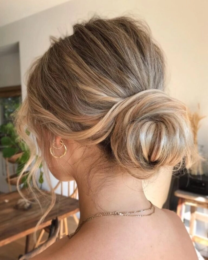 Woman with a relaxed low bun hairstyle perfect for women over 40 in casual settings