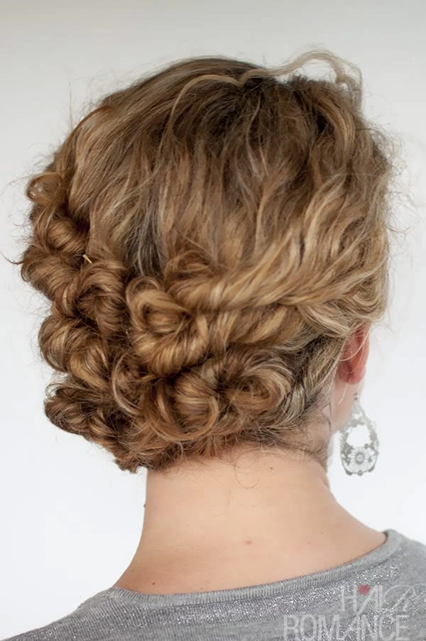 Relaxed pinned up style showcasing medium curly hair with a casual, effortless look
