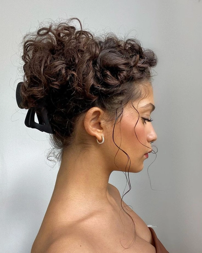 Relaxed pinned up hairstyle for medium curly hair in a casual setting