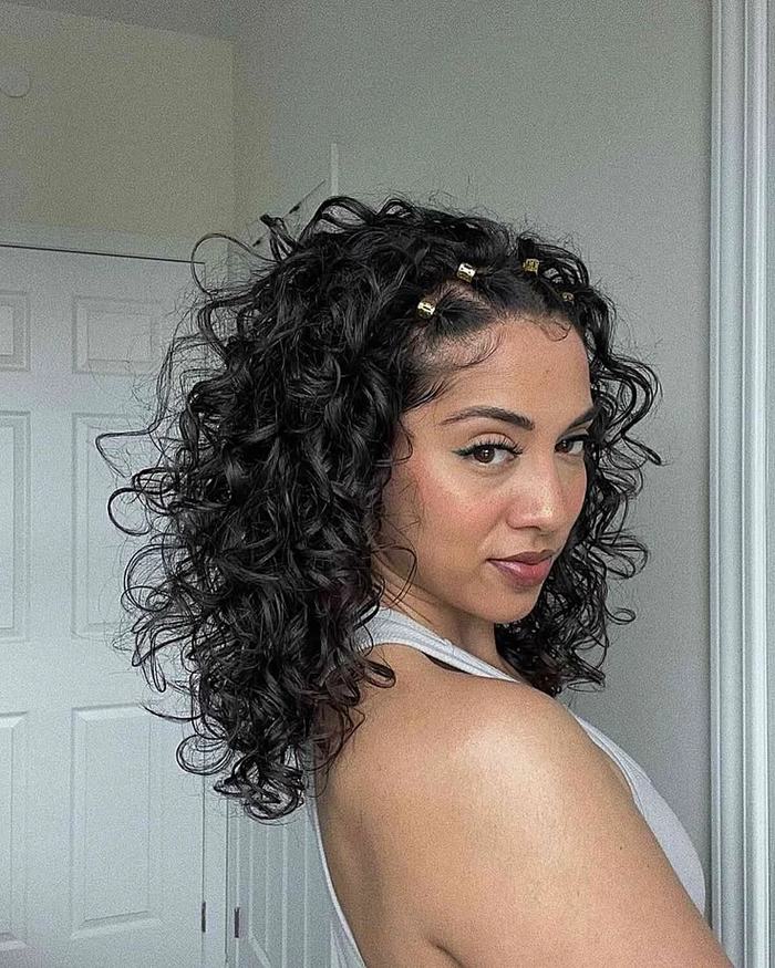 Relaxed pinned up hairstyle for medium curly hair in a casual setting