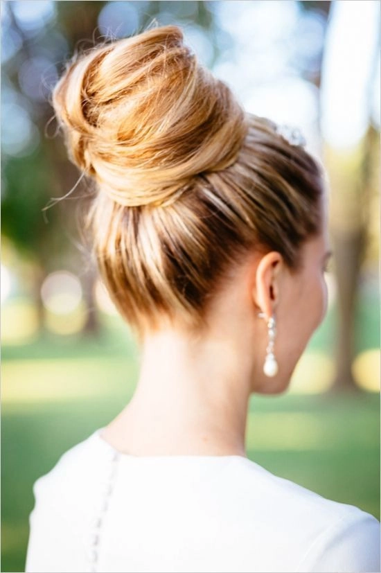 Woman with a relaxed top knot hairstyle ideal for humid weather