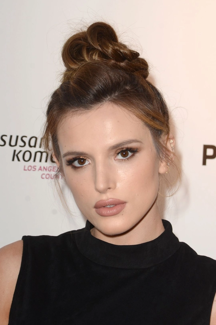 Relaxed top knot hairstyle perfect for humid weather and casual looks