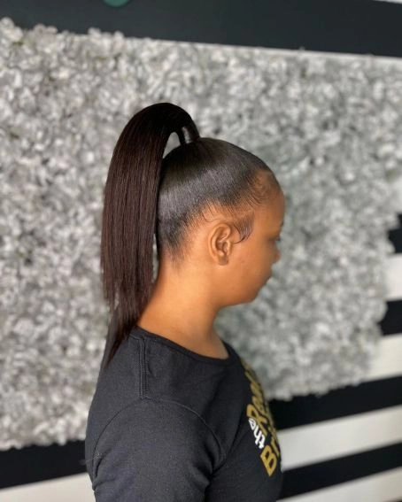 Relaxed top knot hairstyle perfect for humid weather casual looks