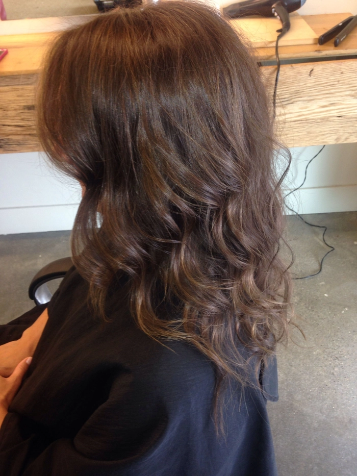 Relaxed tousled waves on long highlighted hair for a casual chic look