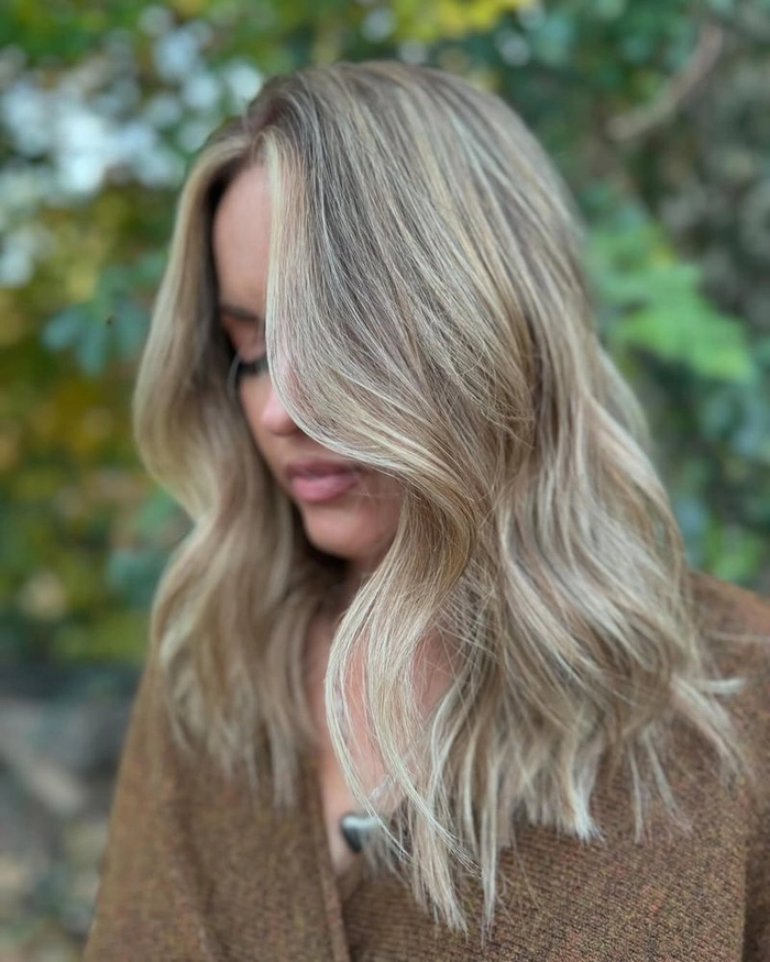 Relaxed tousled waves on long highlighted hair for a casual look