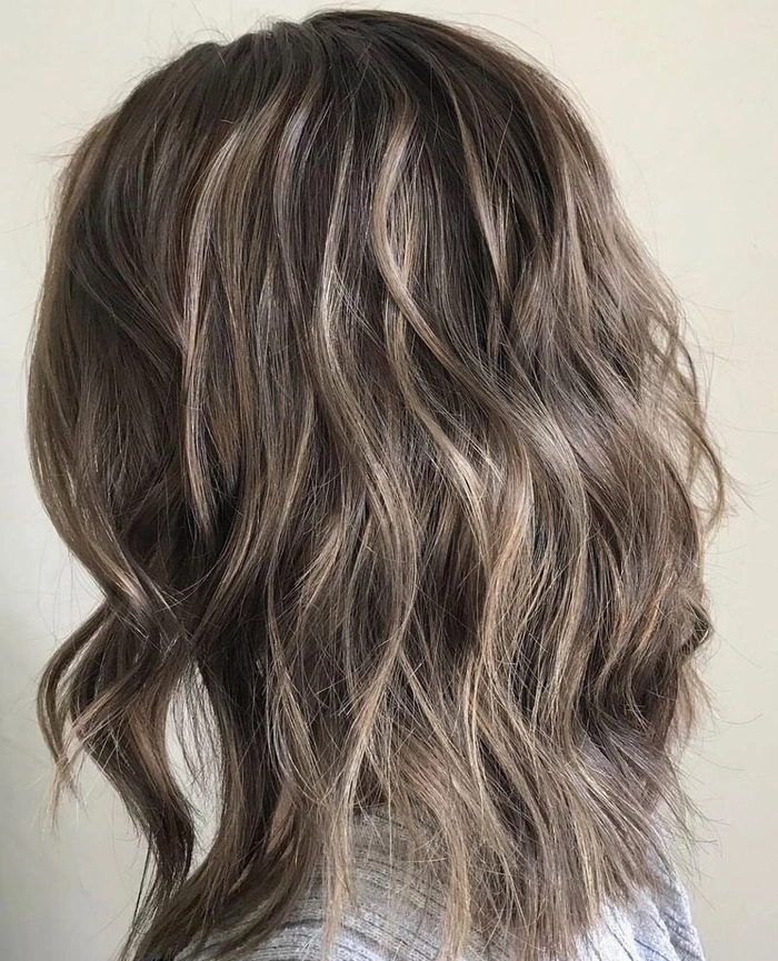 Relaxed tousled waves cascading through long highlighted hair for a casual look