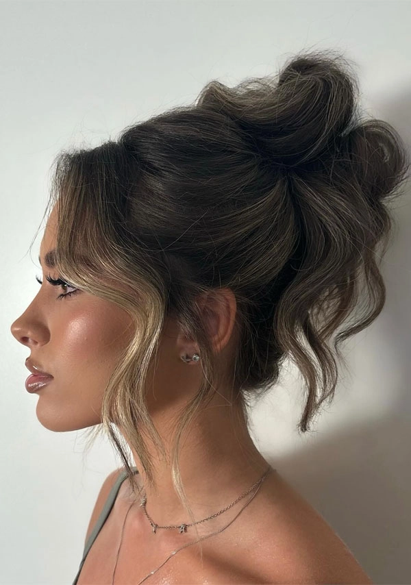 Casual Hairstyle 8 - Relaxed Updo with Face Framing Pieces for Round Faces A relaxed updo with soft face framing pieces for round faces, casual and effortless style