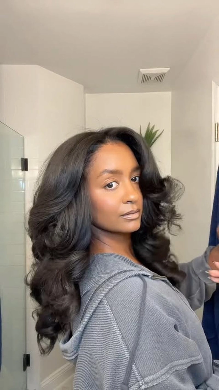 Perfect long weekend brunch look featuring a soft voluminous blowout Woman with a relaxed voluminous blowout hairstyle seated outdoors for a casual brunch