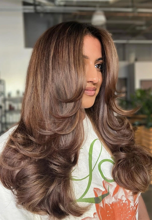 Long cascading blowout with soft volume perfect for a brunch date Relaxed voluminous blowout hairstyle for a long casual weekend brunch