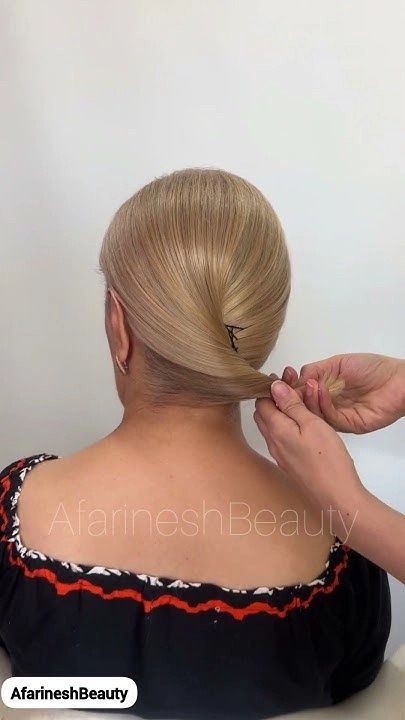 Short hair styled in a casual French twist with soft volume and loose strands