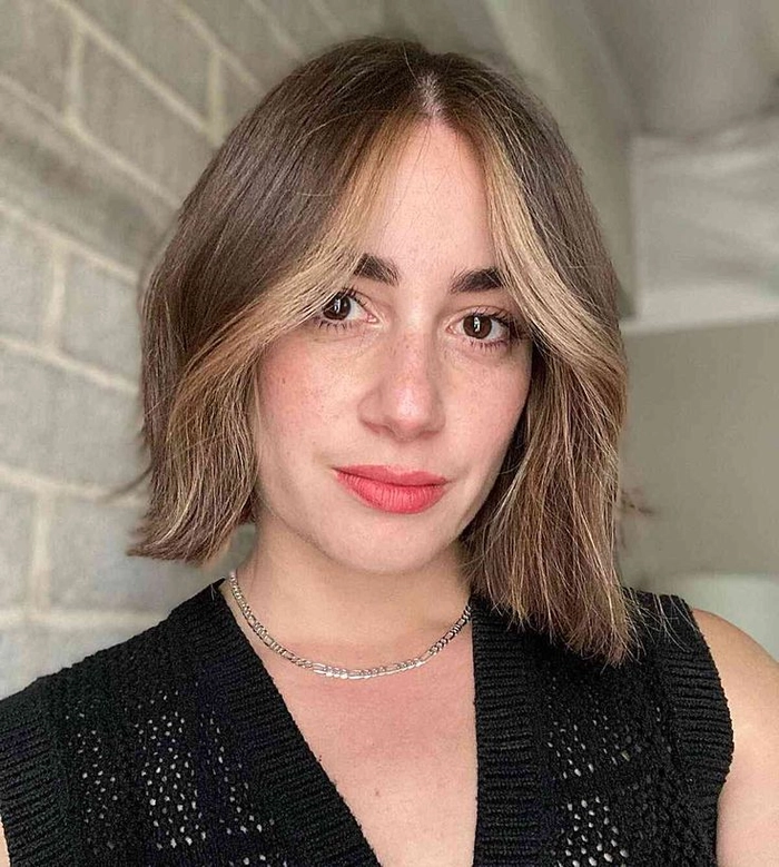 Simple tucked behind ears styling for a blunt bob haircut