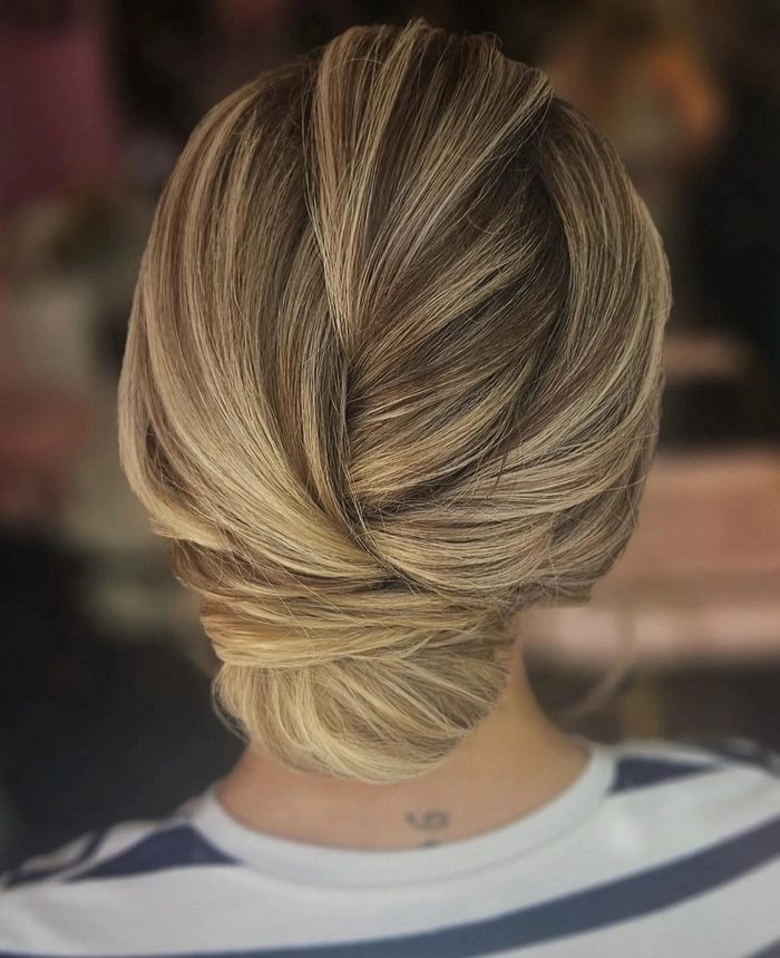 Woman with a simple twisted updo hairstyle perfect for casual Friday office wear