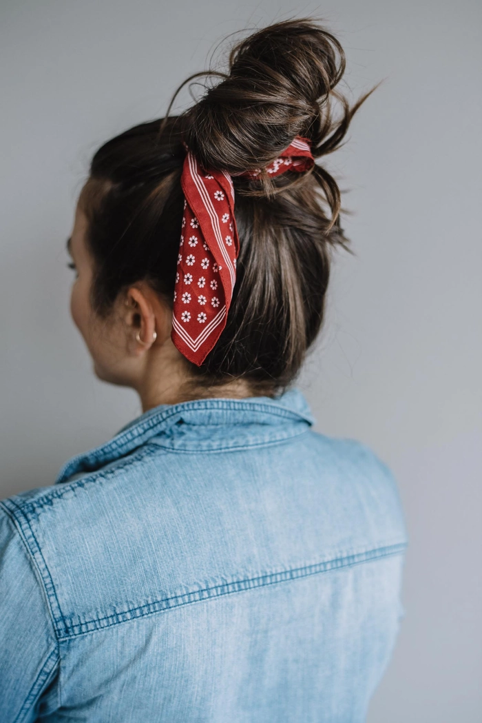 Effortless casual hairstyle featuring a vibrant bandana ponytail look Woman showcasing a quick bandana ponytail style for retro casual vibes