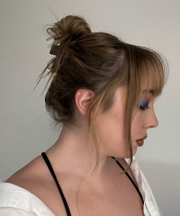 Simple Clip In Bangs Styling for Casual Makeovers Woman with a simple clip in bangs styling for casual makeovers