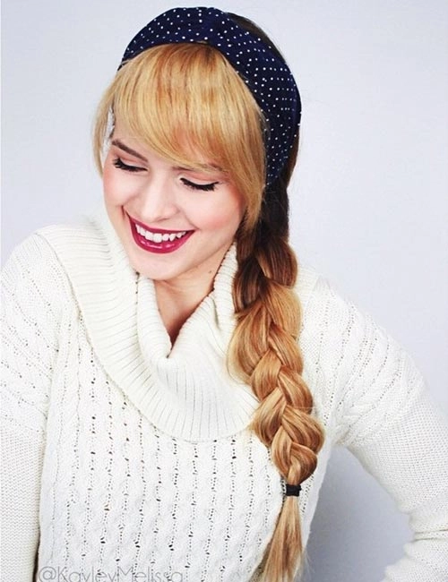 Woman wearing a casual braided headband with long straight hair in a relaxed outdoor setting