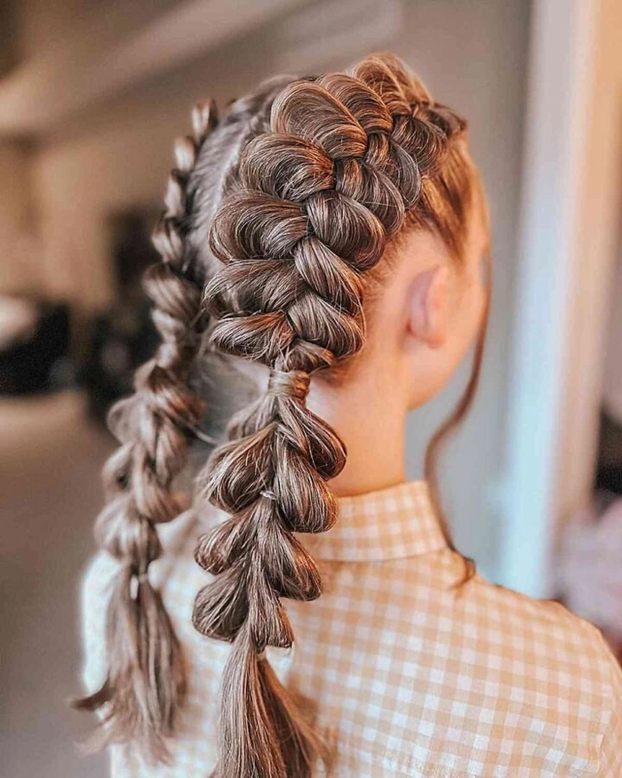 Woman with quick braided pigtails working on outdoor garden chores in a casual sunny setting
