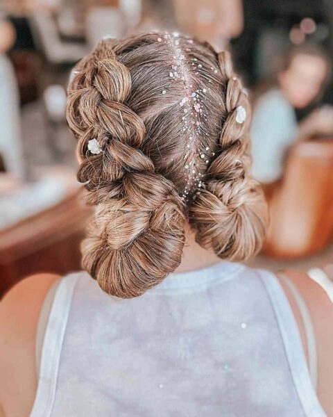 Woman with quick braided pigtails gardening in her backyard