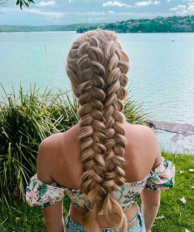 Woman with quick braided pigtails doing casual outdoor chores in the backyard