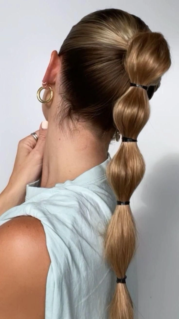 Woman with a casual bubble braid ponytail hairstyle for long hair