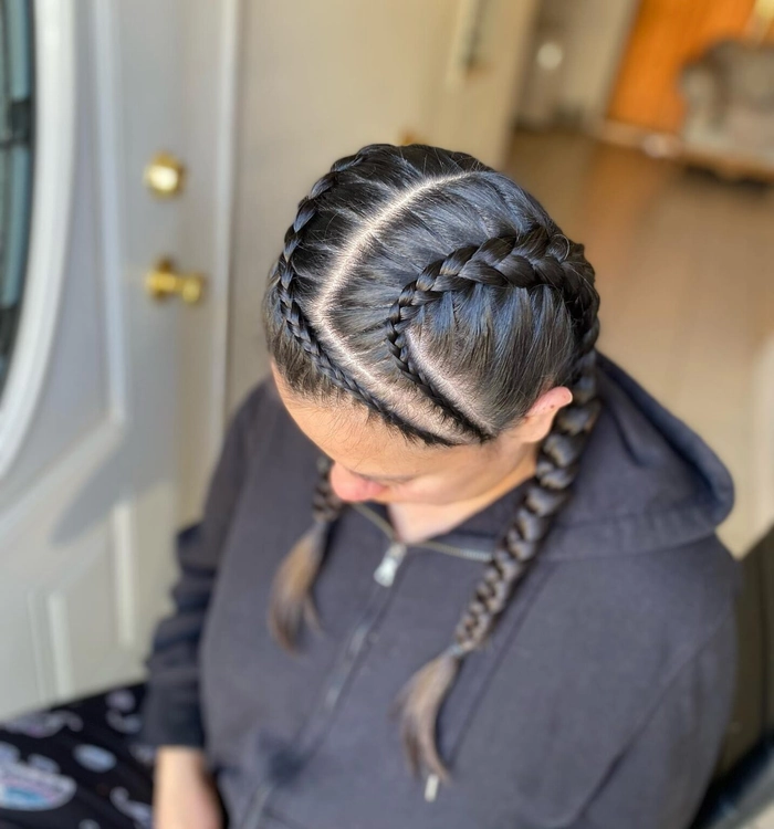 Casual double braids hairstyle ideal for sports and fitness routines Woman wearing casual double braids suited for athletic activities outdoors