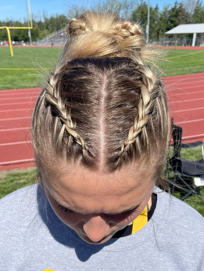 Casual double braids hairstyle ideal for sporty looks and comfort Woman with casual double braids styled for athletic activities