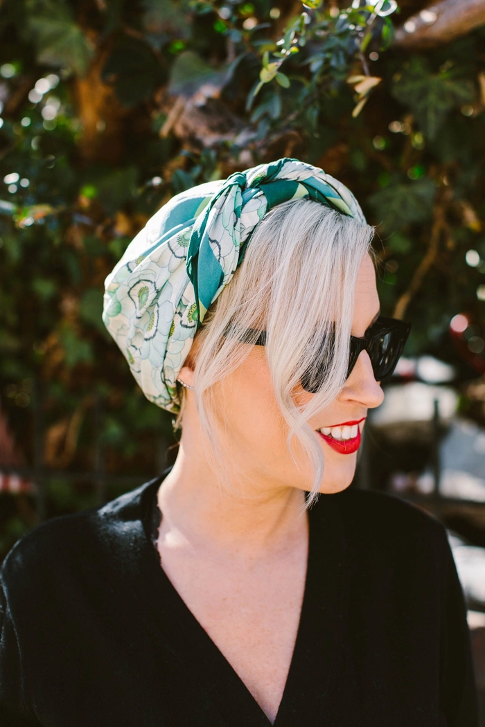 Woman wearing a casual scarf wrapped stylishly to protect her hair in winter