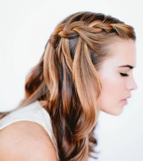 Elegant casual waterfall braid hairstyle perfect for romantic evenings Woman with a casual waterfall braid styled for a date night outing