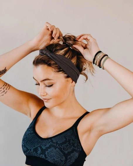 Effortless bandana hairstyle to tame hair on challenging days Woman wearing a colorful bandana with loose waves for a casual bad hair day look
