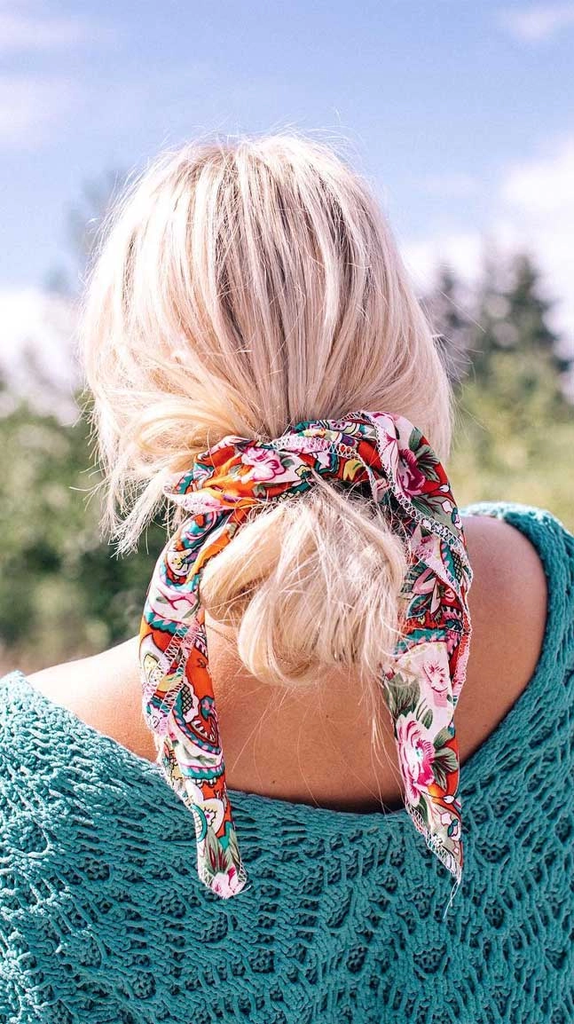 Woman wearing a cozy casual scarf hairstyle to protect hair in winter