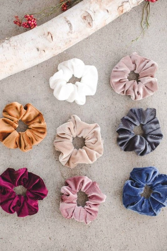 Woman with a cozy winter casual updo secured by a simple velvet scrunchie
