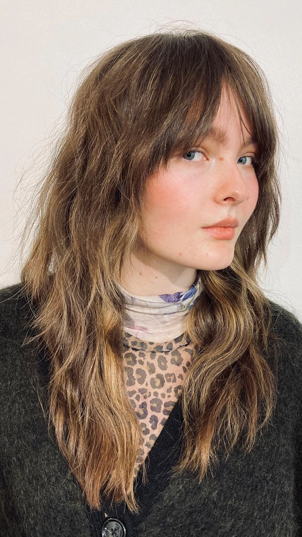 Effortless shag haircut perfect for relaxed weekend styling Woman with effortless shag haircut styled for casual weekends