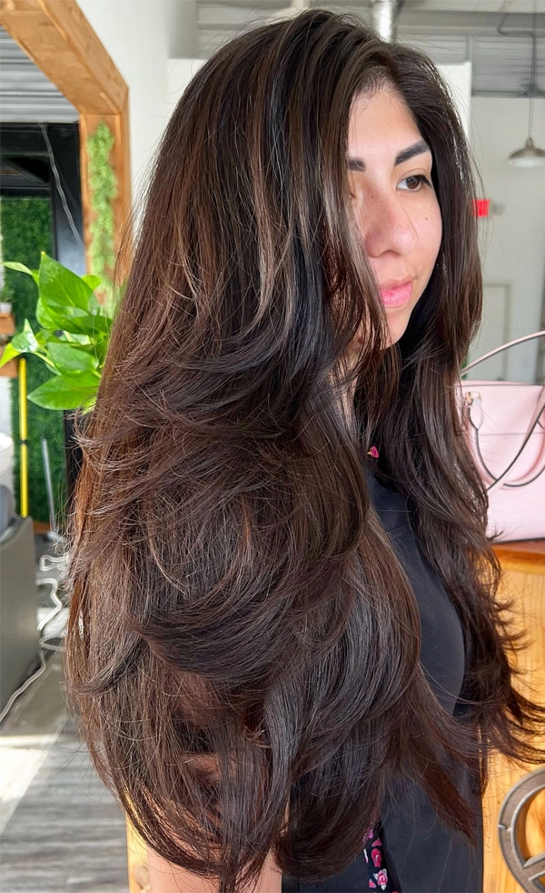 Woman with everyday layered hair styling for natural volume in casual setting