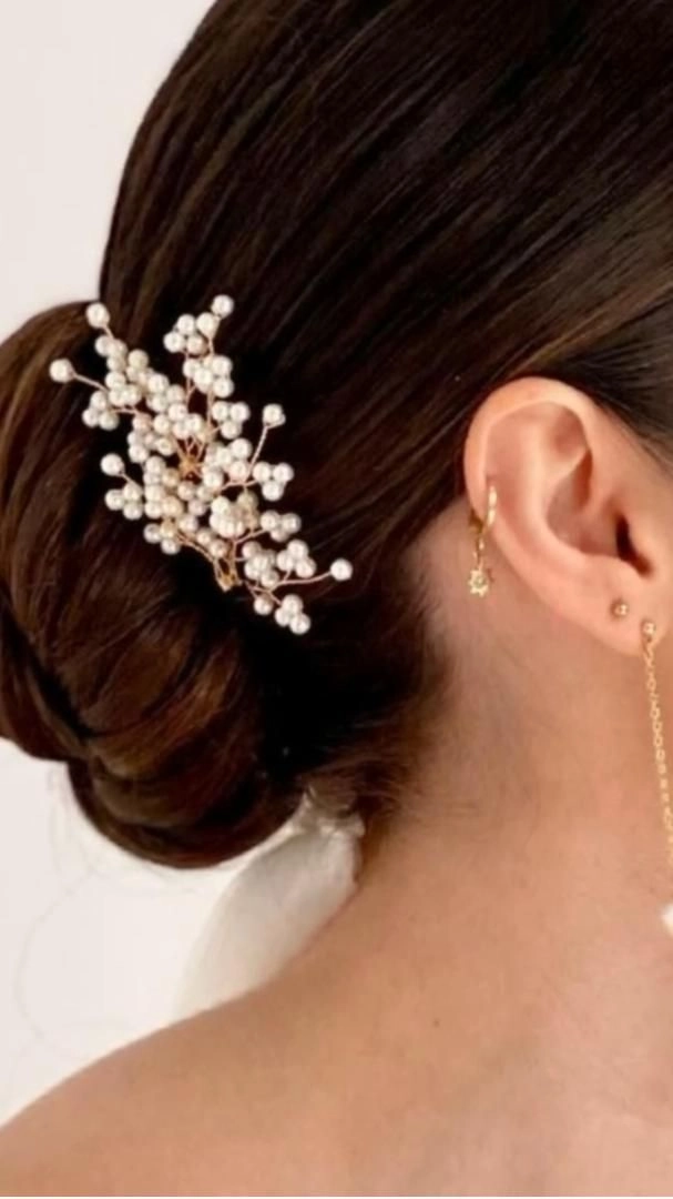 Simple pearl hair pin updo for casual holiday party Woman with casual updo using pearl hair pins for holiday gathering