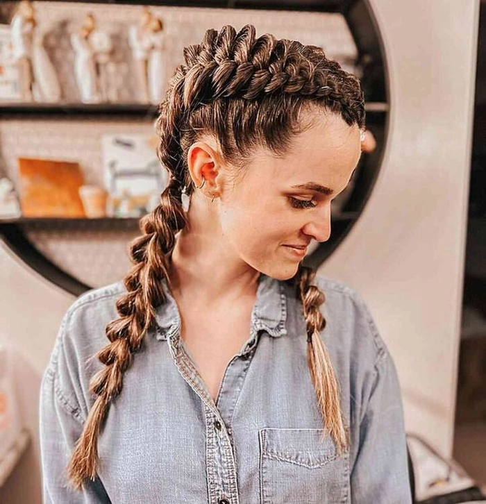 Woman wearing quick braided pigtails while doing outdoor chores in casual clothes