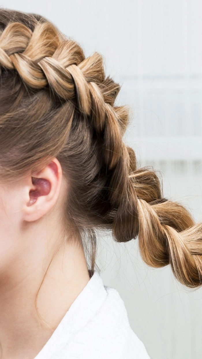 Woman wearing quick braided pigtails while doing outdoor chores