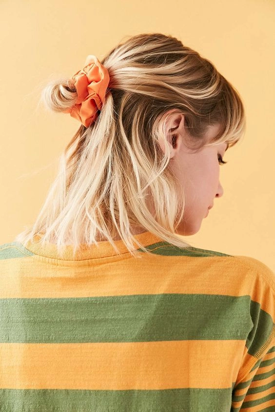 Woman with a quick scrunchie hairstyle showcasing 90s casual aesthetics